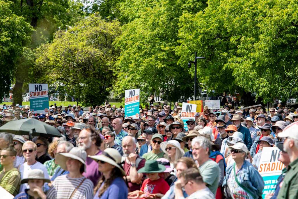 Crowd rallies against Macquarie Point stadium on Parliament Lawns ...