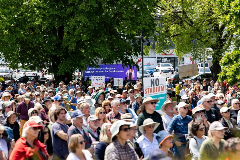 Crowd rallies against Macquarie Point stadium on Parliament Lawns ...